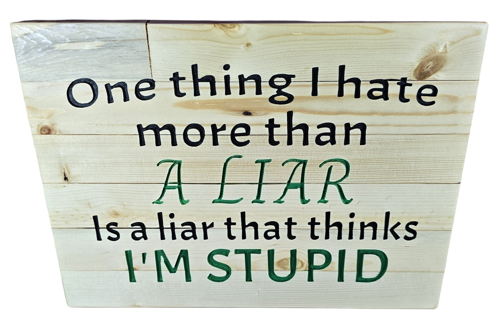 TK Wood Designs natural wood wall art with black and green text: "One thing I hate more than a liar is a liar that thinks I'm stupid."