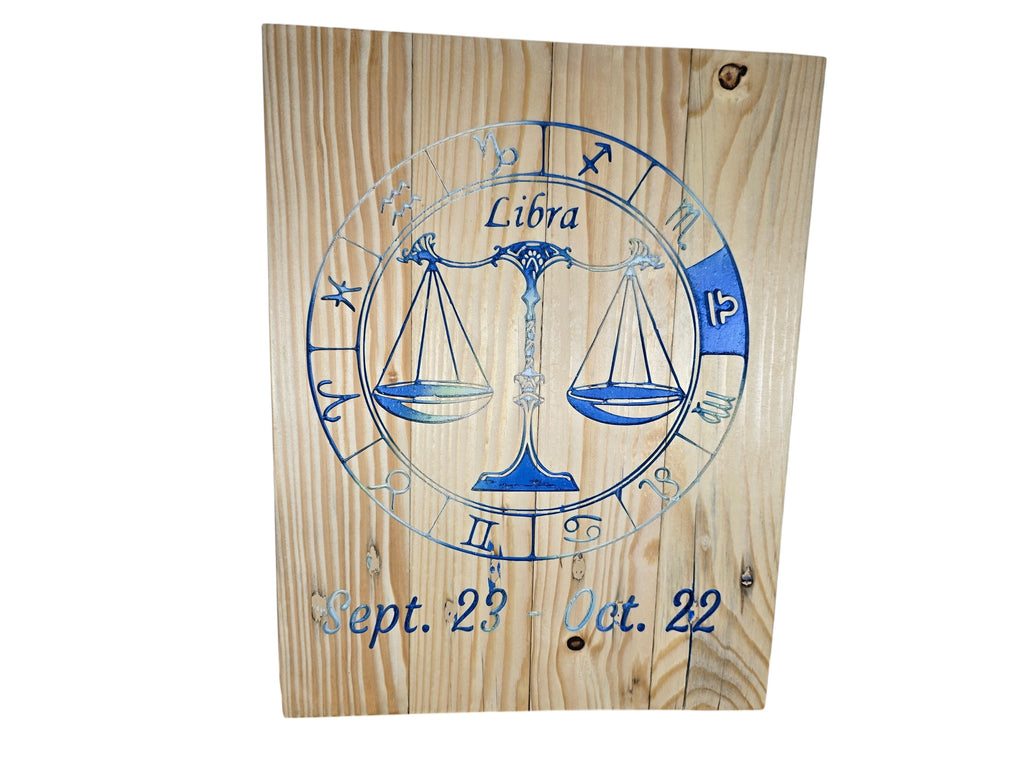 TK Wood Designs Libra zodiac wall plaque with blue engraved scales and dates on natural wood grain background.