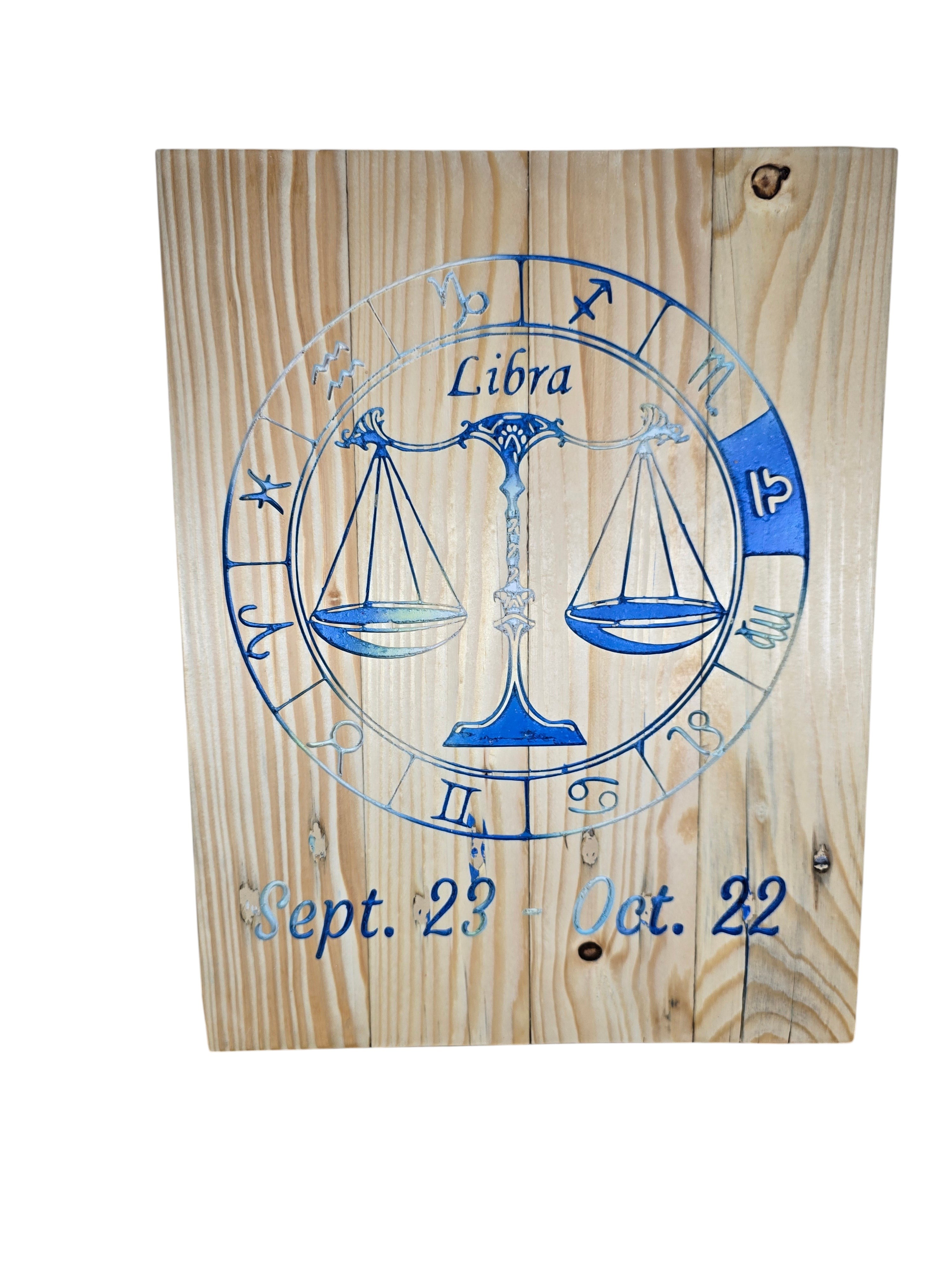 TK Wood Designs Libra zodiac sign wall plaque featuring blue engraved scales and dates on natural wood grain.