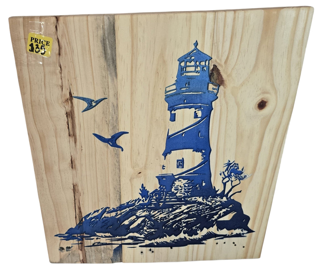 TK Wood Designs natural wood art with blue lighthouse graphic, rocky shore, and seagulls. Coastal theme.