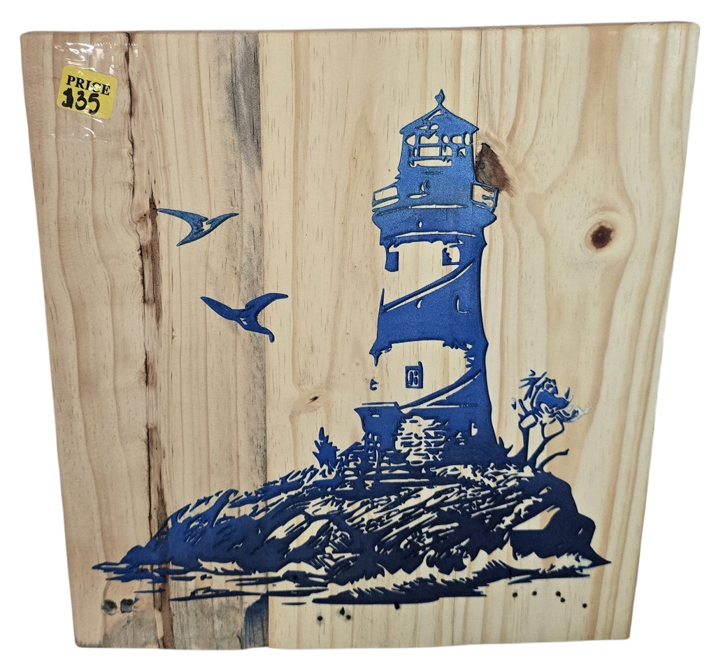 TK Wood Designs natural wood art with blue lighthouse graphic, rocky shore, and seagulls. Coastal theme.