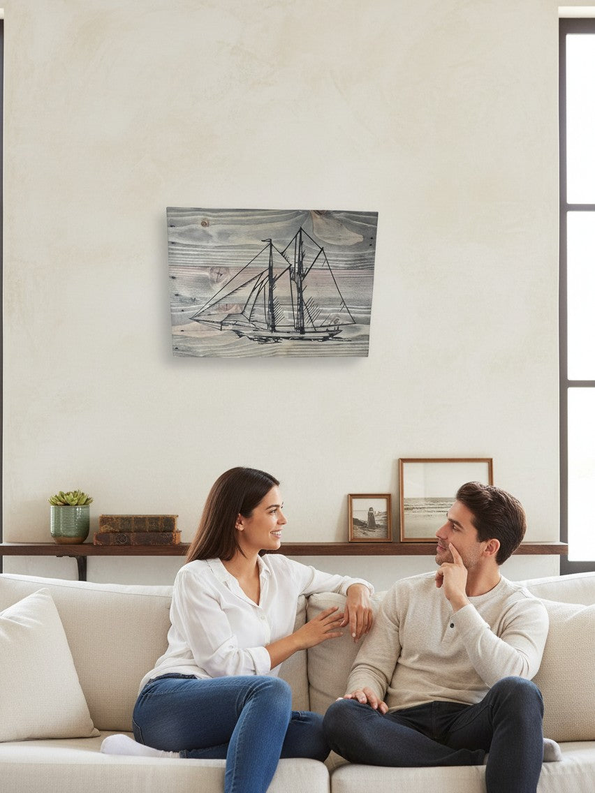 TK Wood Designs handcrafted nautical sailboat wall art on weathered wood displayed above a couple on a sofa