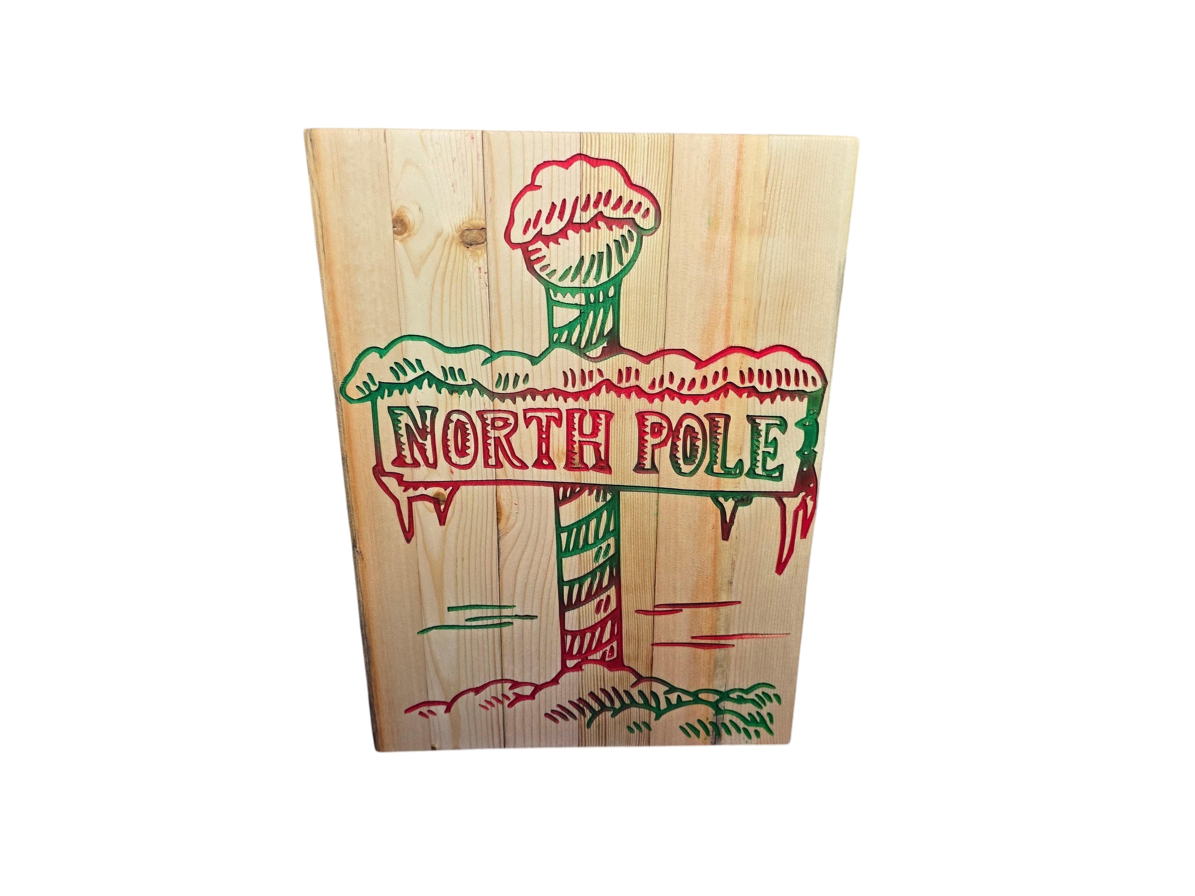 TK Wood Designs North Pole rustic reclaimed wood Christmas sign, hand-painted with red and green festive lettering and snowy accents.