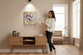 TK Wood Designs Pisces zodiac wooden wall art with purple fish engraving hanging in a modern living room.