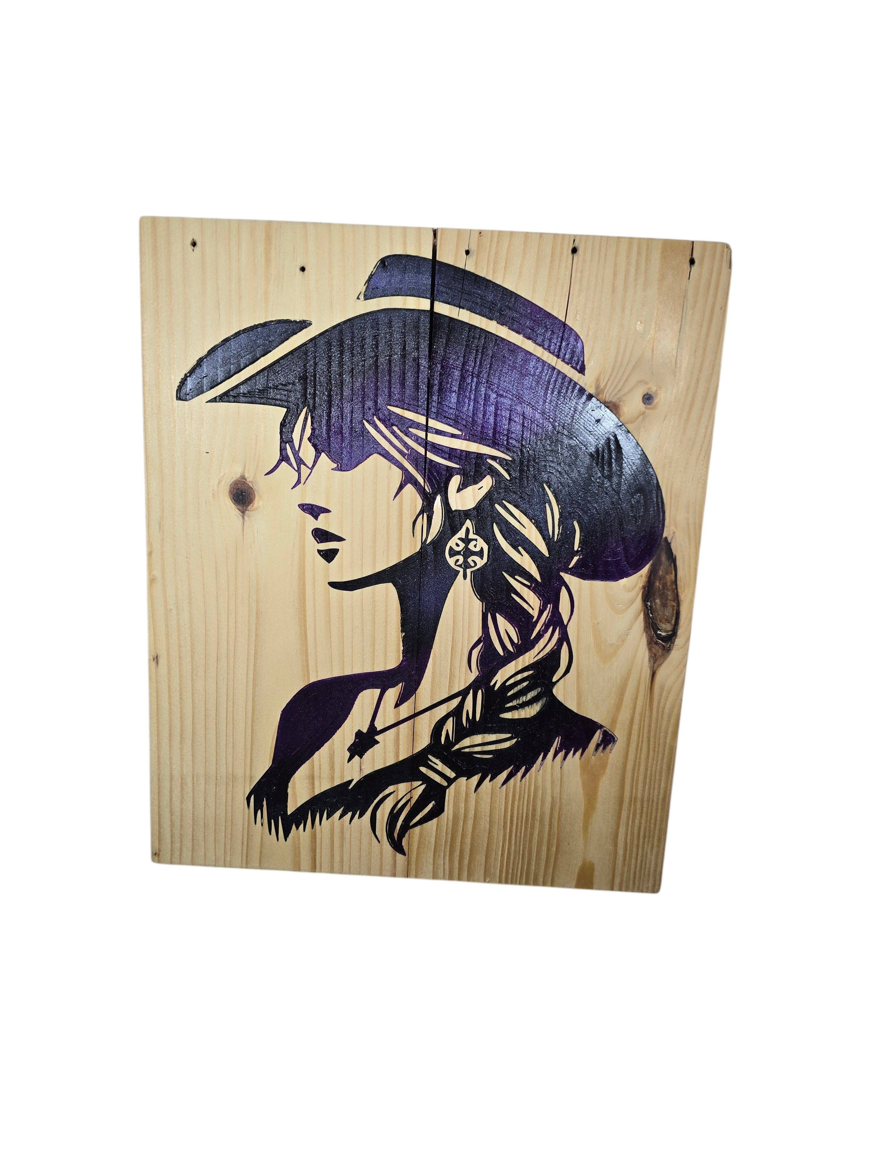 TK Wood Designs natural wood art with a black and purple cowgirl silhouette, featuring a wide-brimmed hat and braided hair.