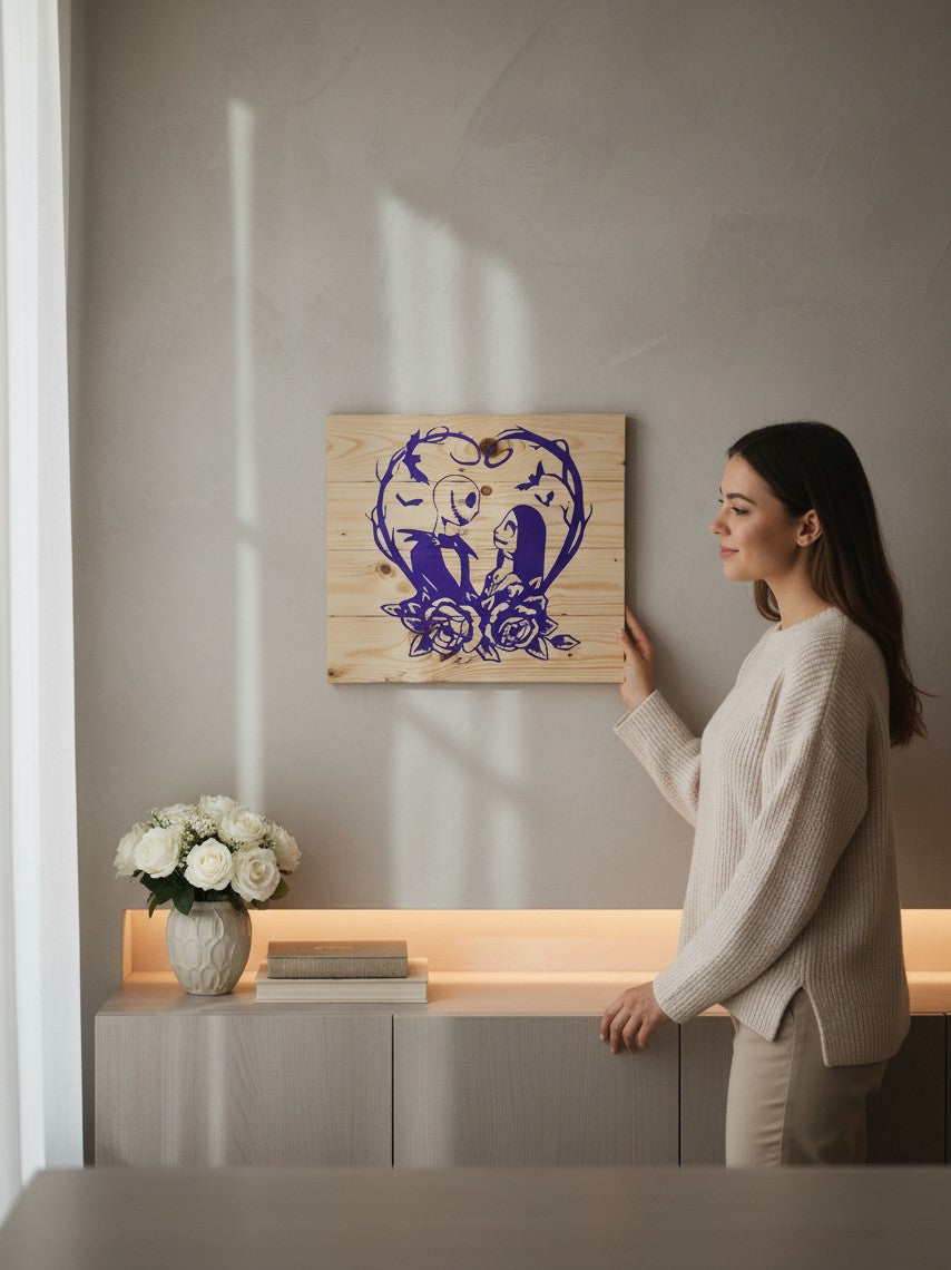 A woman holding a TK Wood Designs purple silhouette wooden plaque featuring a spooky couple inside a heart of roses.