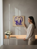 A woman holding a TK Wood Designs purple silhouette wooden plaque featuring a spooky couple inside a heart of roses.