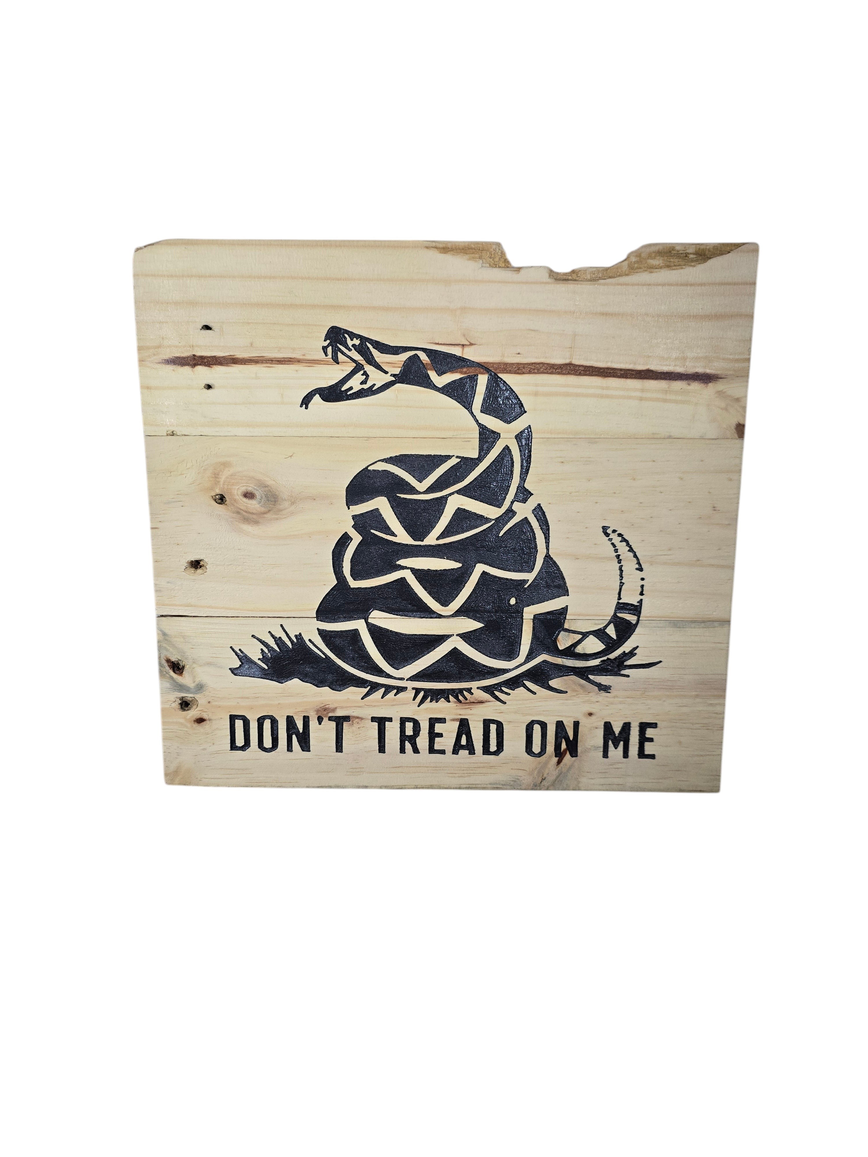 TK Wood Designs natural wood wall art featuring a black coiled rattlesnake graphic and "Don't Tread On Me" text.