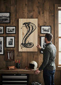 TK Wood Designs carved cobra sculpture from reclaimed wood, featuring a black cobra in a striking pose on a natural wood background.