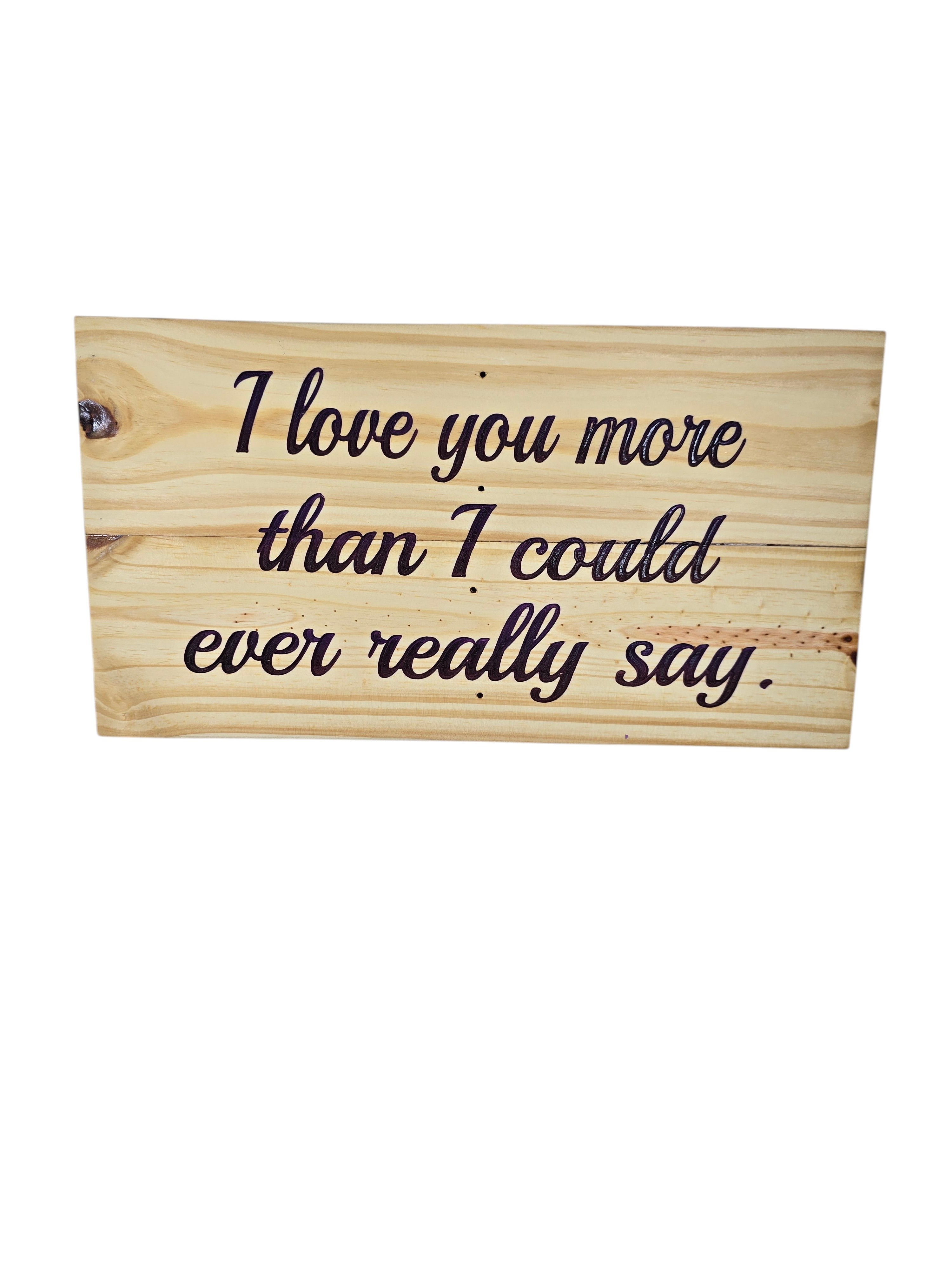 TK Wood Designs rustic reclaimed wood sign with hand-painted lettering that says "I love you more than I could ever really say."