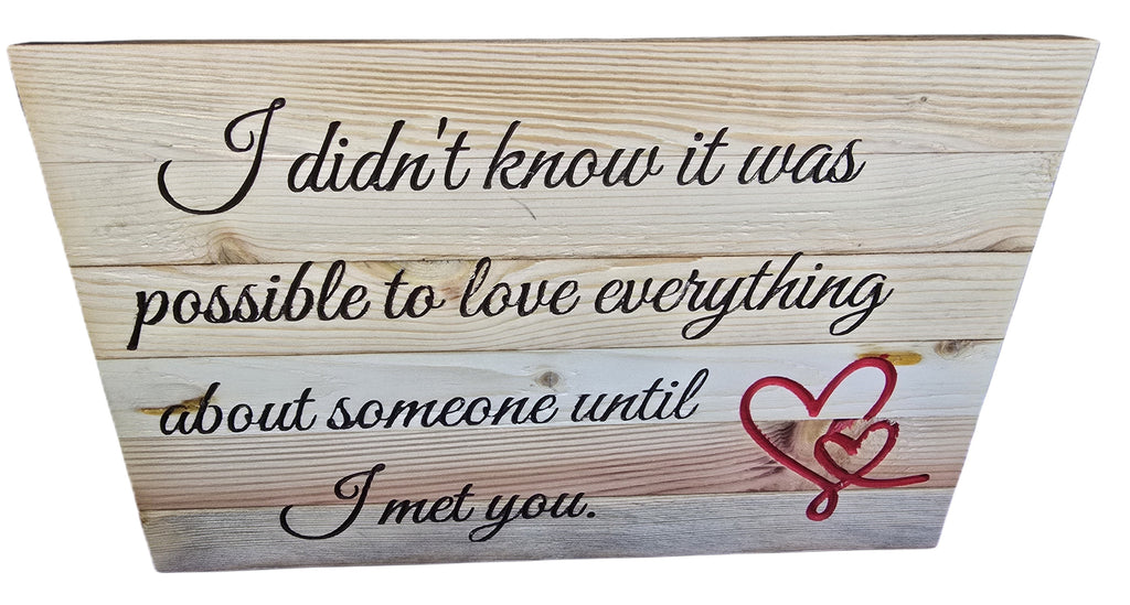 TK Wood Designs reclaimed wood sign with hand-crafted lettering reading "I didn't know it was possible to love everything about someone until I met you." Features red hearts.