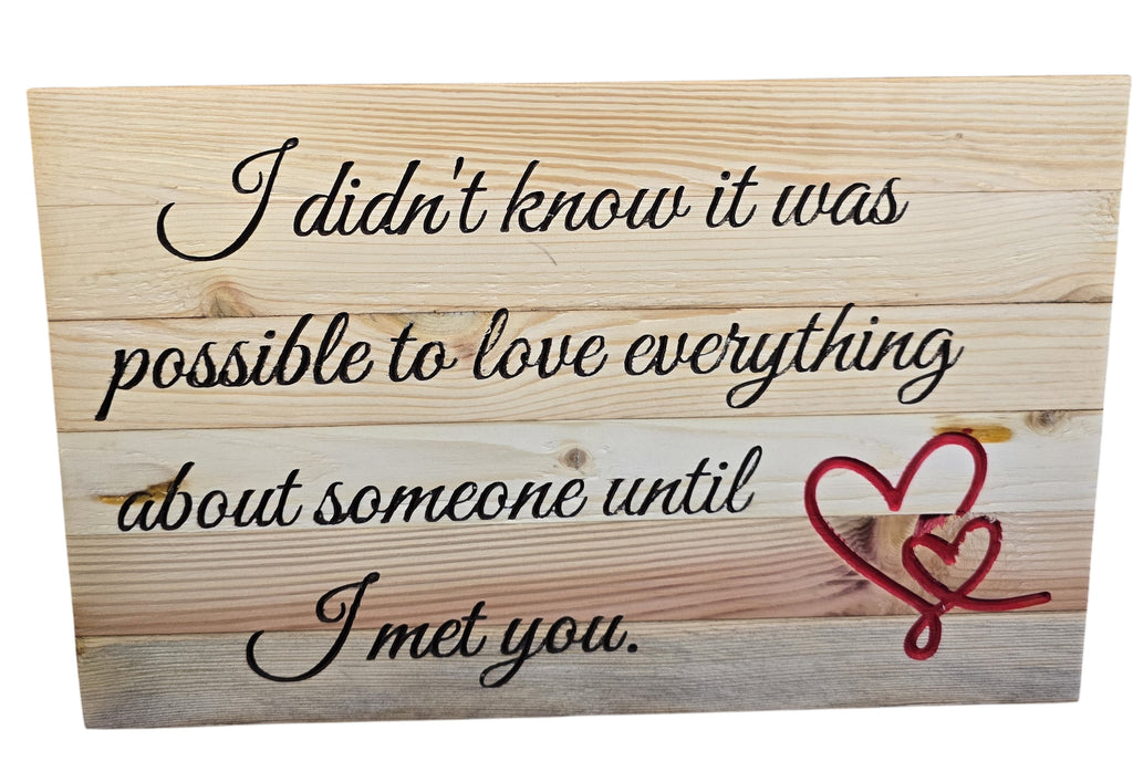 TK Wood Designs reclaimed wood sign with hand-crafted lettering and red hearts. Features quote: "I didn't know it was possible to love everything about someone until I met you."