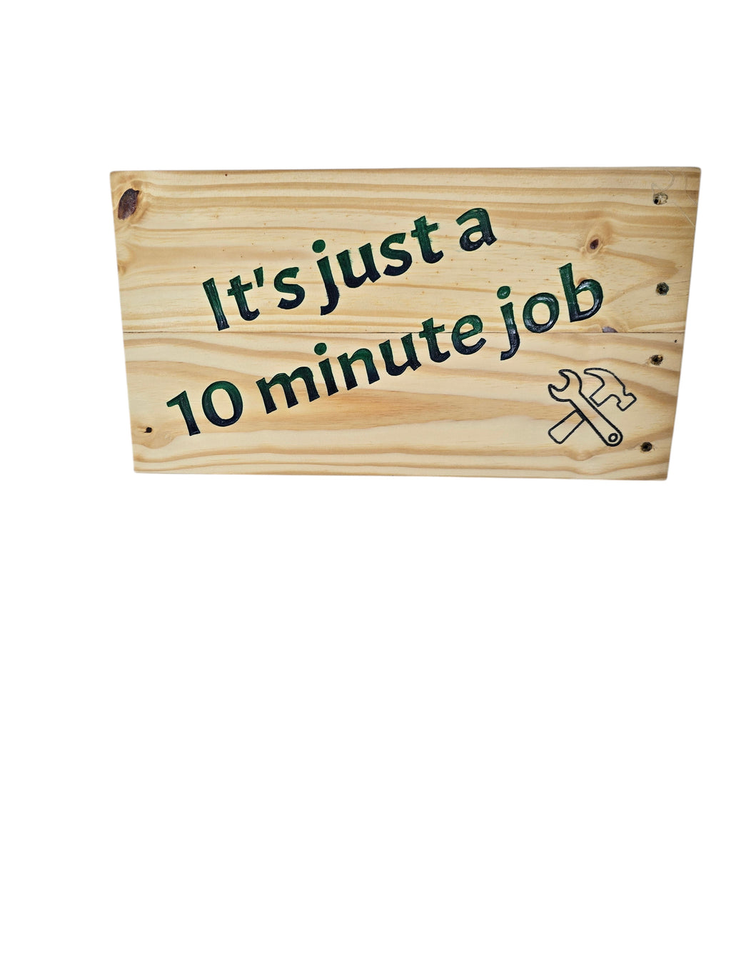 TK Wood Designs reclaimed wood sign with hand-painted green text "It's just a 10 minute Job" and a hammer and wrench graphic.