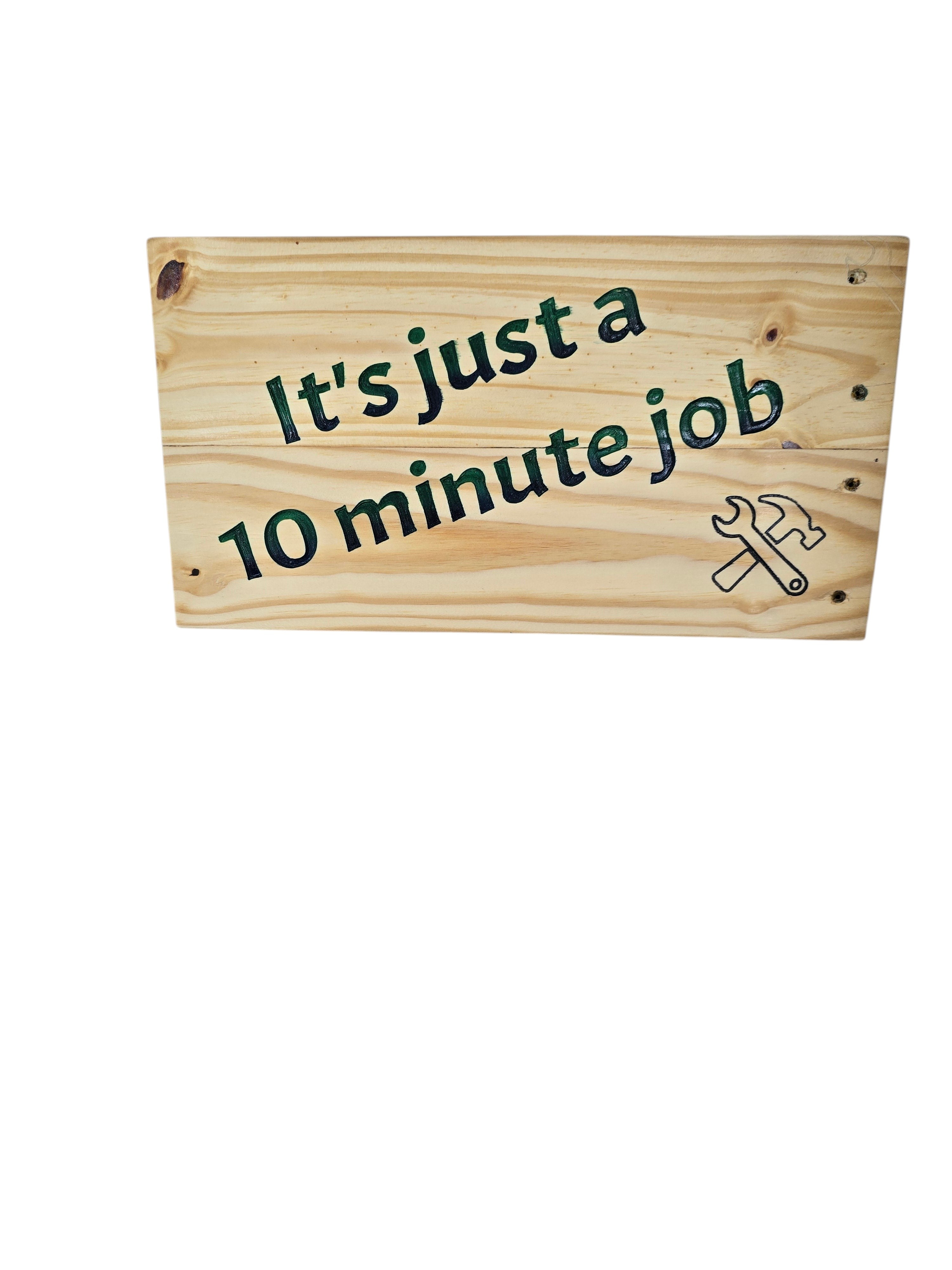 TK Wood Designs handmade reclaimed wood sign with hand-painted "It's just a 10 minute Job" text and a wrench/hammer graphic.
