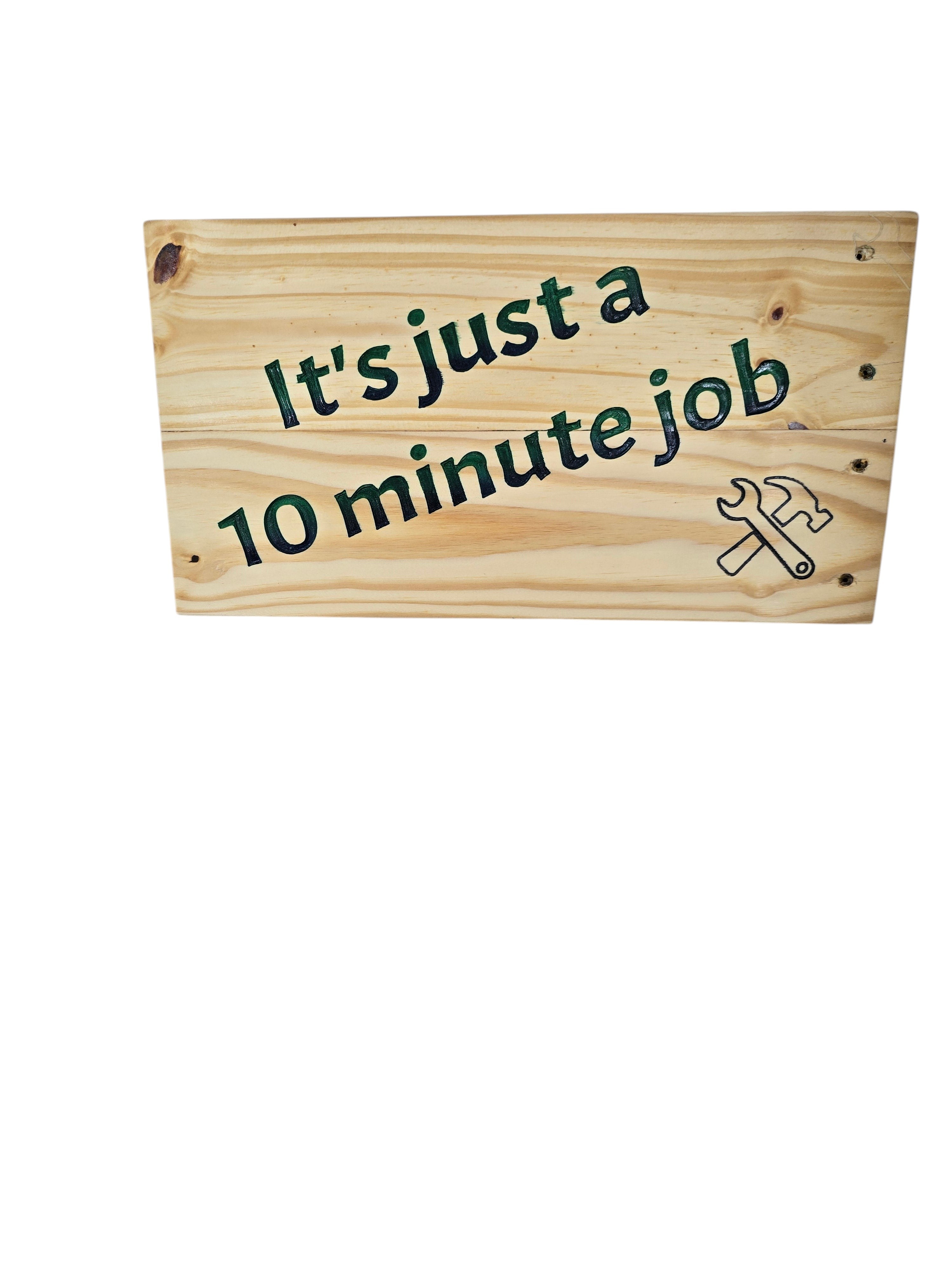 TK Wood Designs handmade reclaimed wood sign with hand-painted text "It's just a 10 minute Job" and a wrench/hammer graphic.