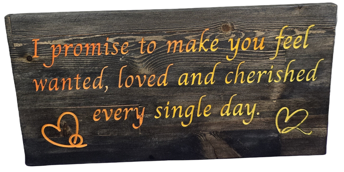 TK Wood Designs reclaimed wood sign with hand-painted orange and yellow text reading 'I promise to make you feel wanted, loved and cherished every single day.' Includes heart and peace sign graphics.