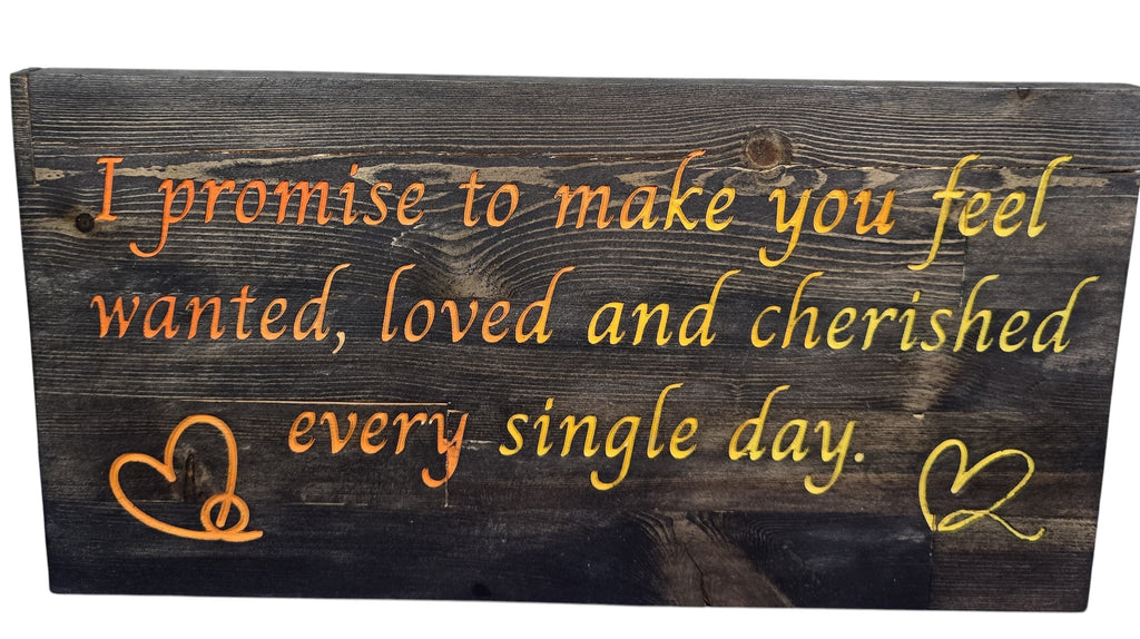 TK Wood Designs reclaimed wood sign with orange and yellow painted text: "I promise to make you feel wanted, loved and cherished every single day." Includes two heart designs.