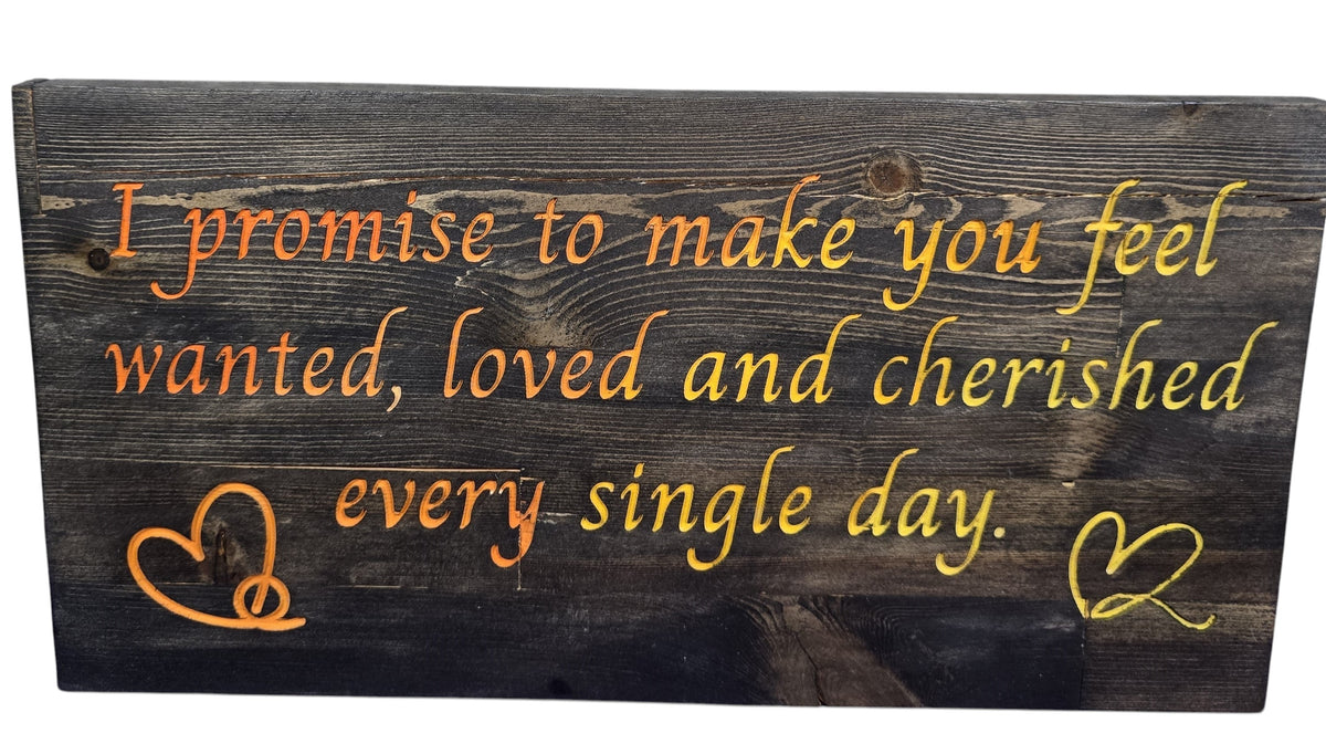TK Wood Designs reclaimed wood sign with orange and yellow painted text: "I promise to make you feel wanted, loved and cherished every single day." Includes two heart designs.