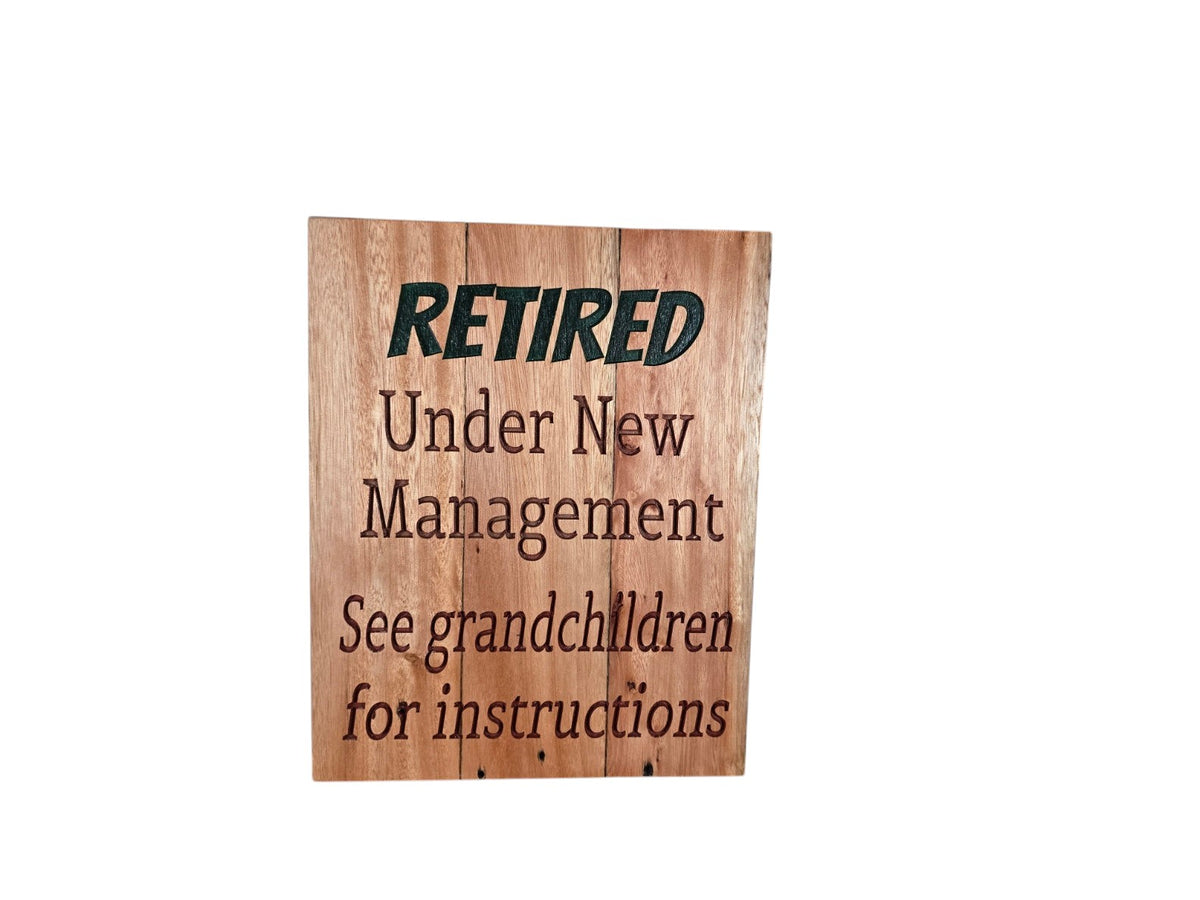TK Wood Designs handcrafted wooden retirement sign with engraved text about grandchildren and new management