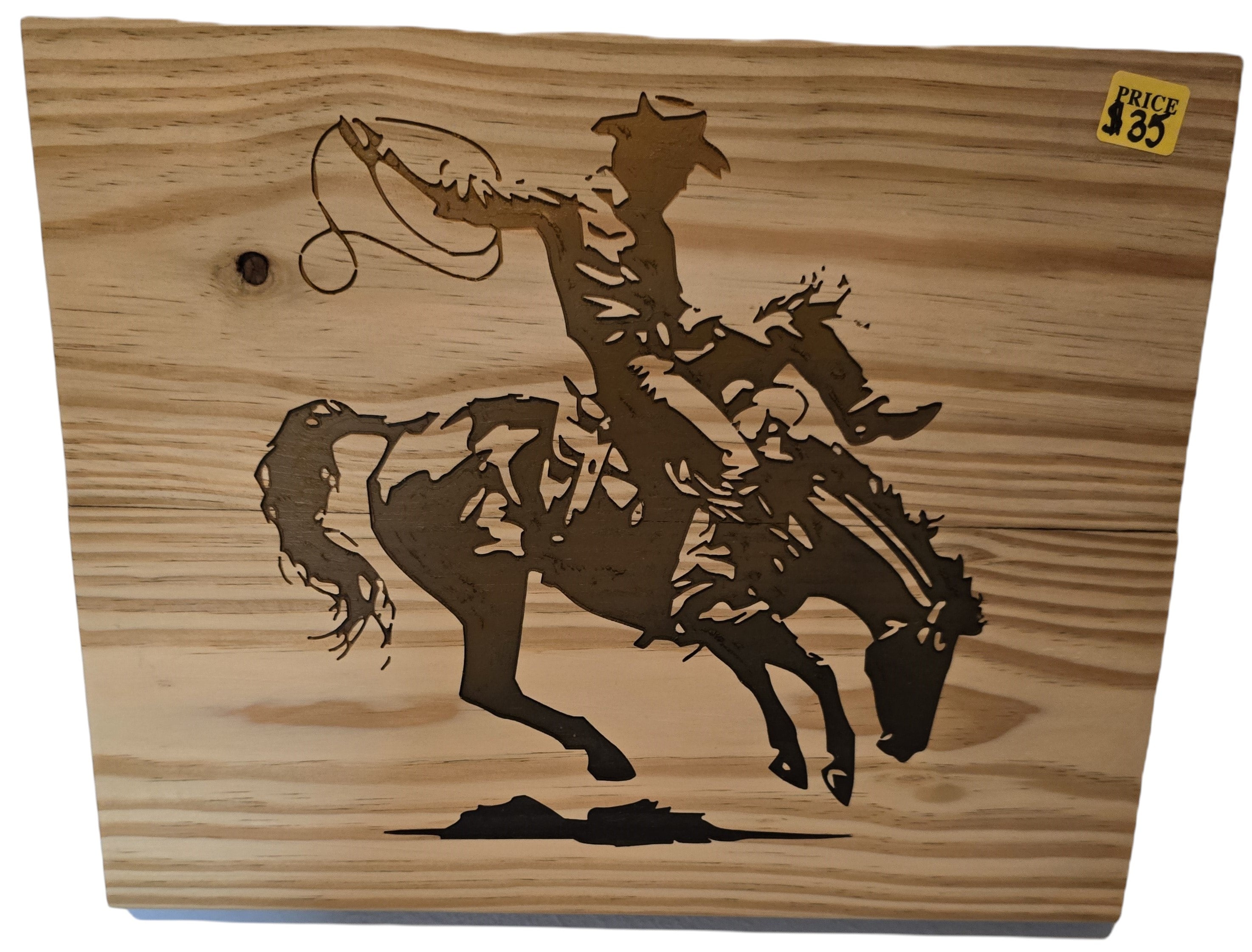 TK Wood Designs natural wood art of a cowboy on a bucking bronco, capturing rodeo action. Rustic silhouette.