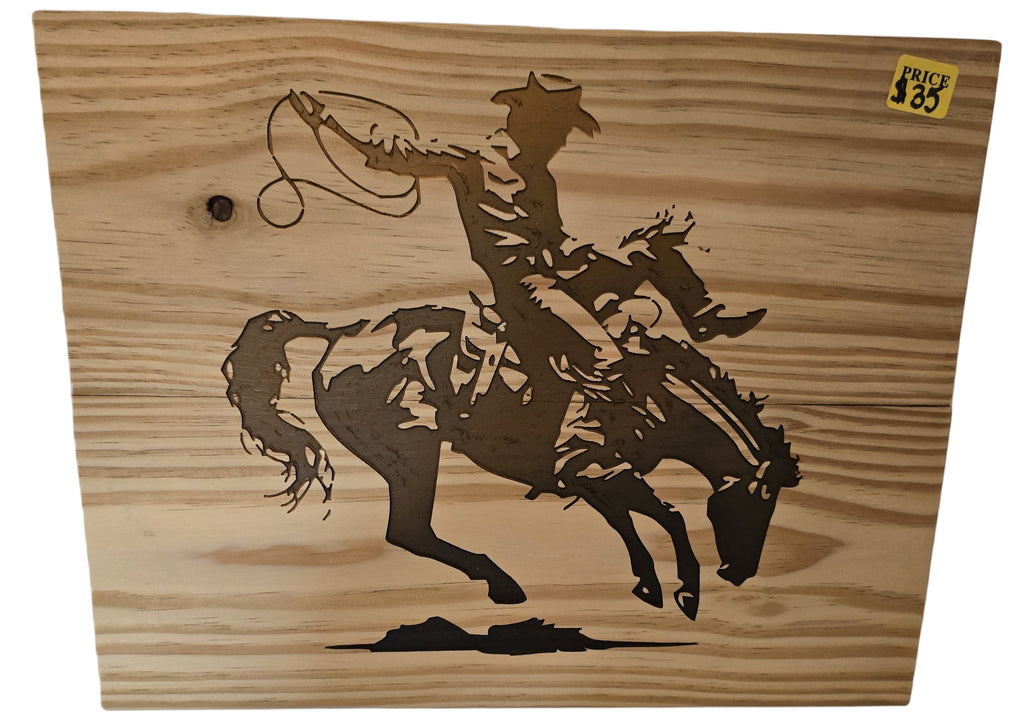 TK Wood Designs natural wood wall art featuring a cowboy on a bucking bronco silhouette. Rustic Western decor.