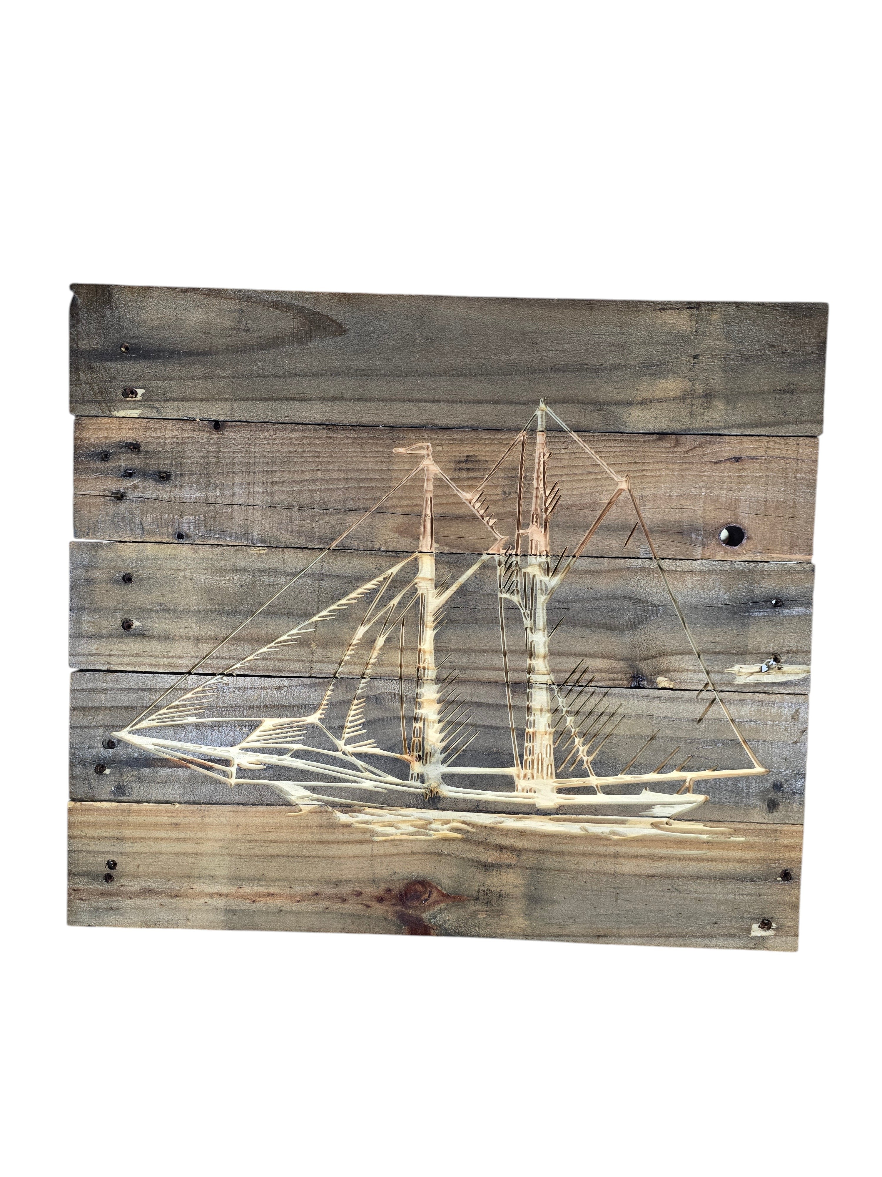 TK Wood Designs rustic wooden wall art featuring an etched sailboat design on weathered reclaimed wood planks.