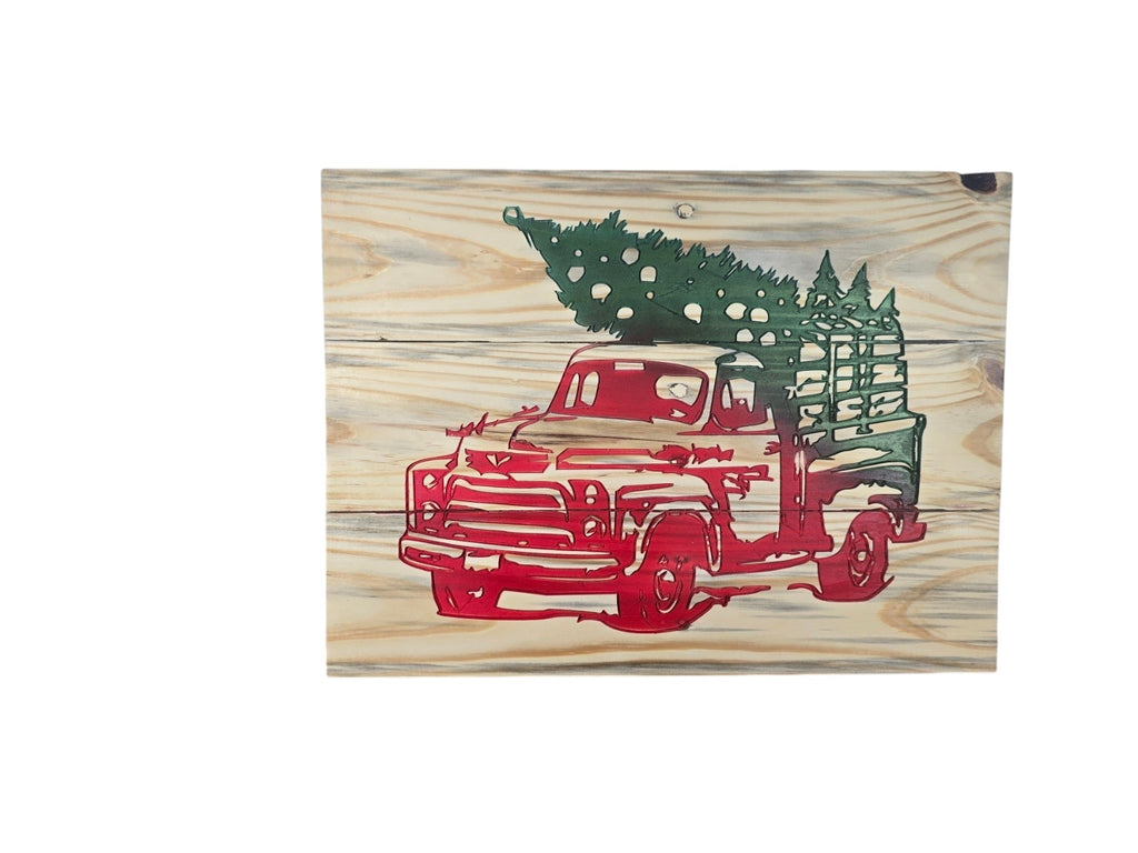 TK Wood Designs rustic wooden wall art featuring a vintage red truck hauling a green Christmas tree on natural wood.