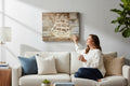 TK Wood Designs rustic wooden wall art featuring a laser-etched sailing ship on reclaimed planks above a sofa.
