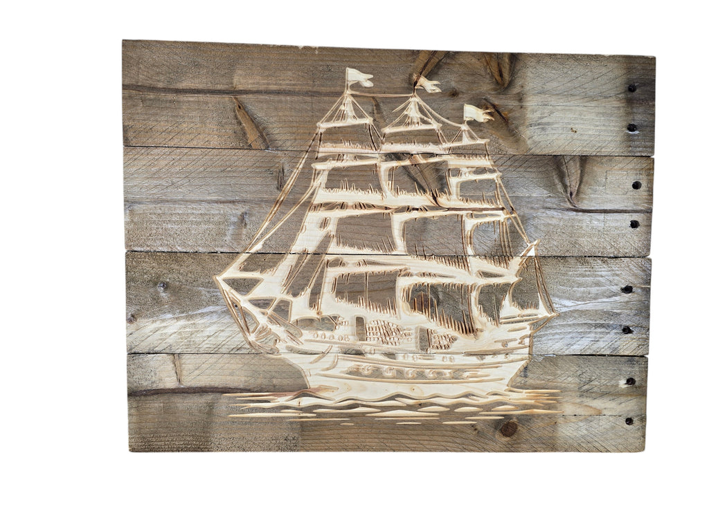 TK Wood Designs rustic wall art featuring a laser-etched sailing ship on weathered reclaimed wood planks.