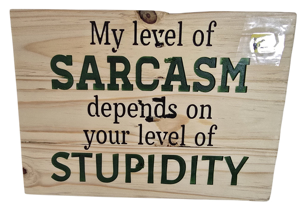 TK Wood Designs natural wood sign with dark green text reading "My Level Of Sarcasm Depends On Your Level Of Stupidity."