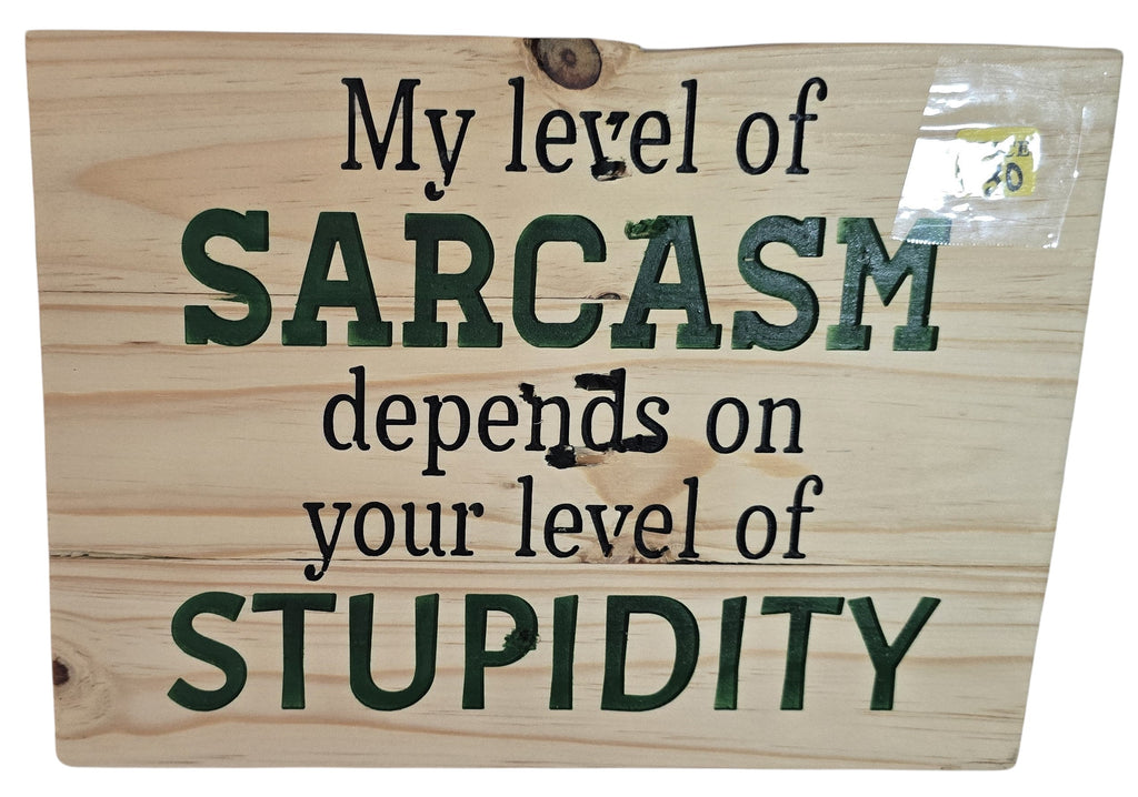 TK Wood Designs natural wood sign with carved text: My level of SARCASTIC depends on your level of STUPIDITY. Dark green and black lettering.