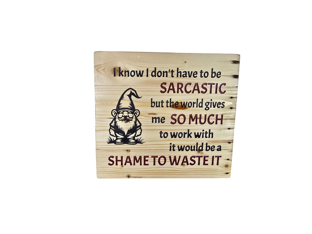 TK Wood Designs wooden sign featuring a gnome illustration and a sarcastic quote about the world in dark lettering.