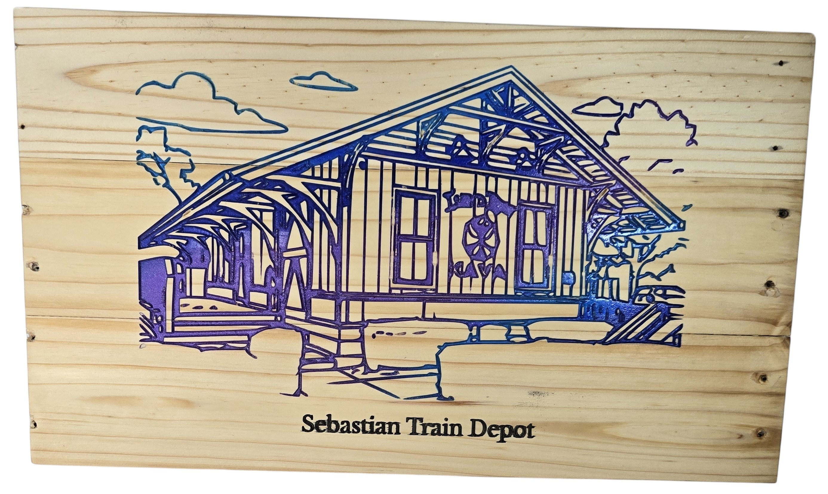 TK Wood Designs Sebastian Train Depot wooden model, featuring a blue and purple engraved depiction of the historic station with clouds and trees.