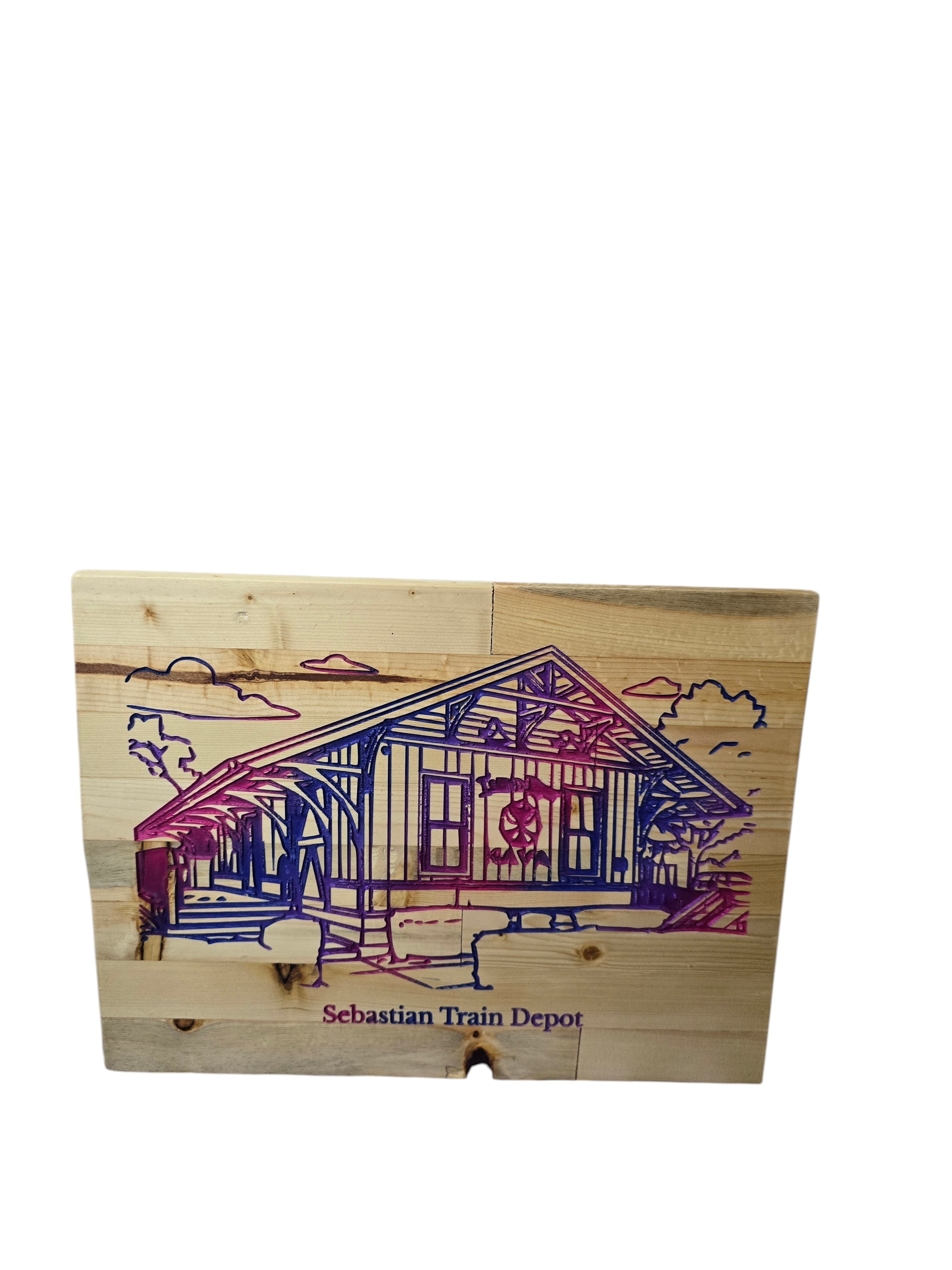 TK Wood Designs Sebastian Train Depot wood wall art with purple and blue accents on natural wood planks.