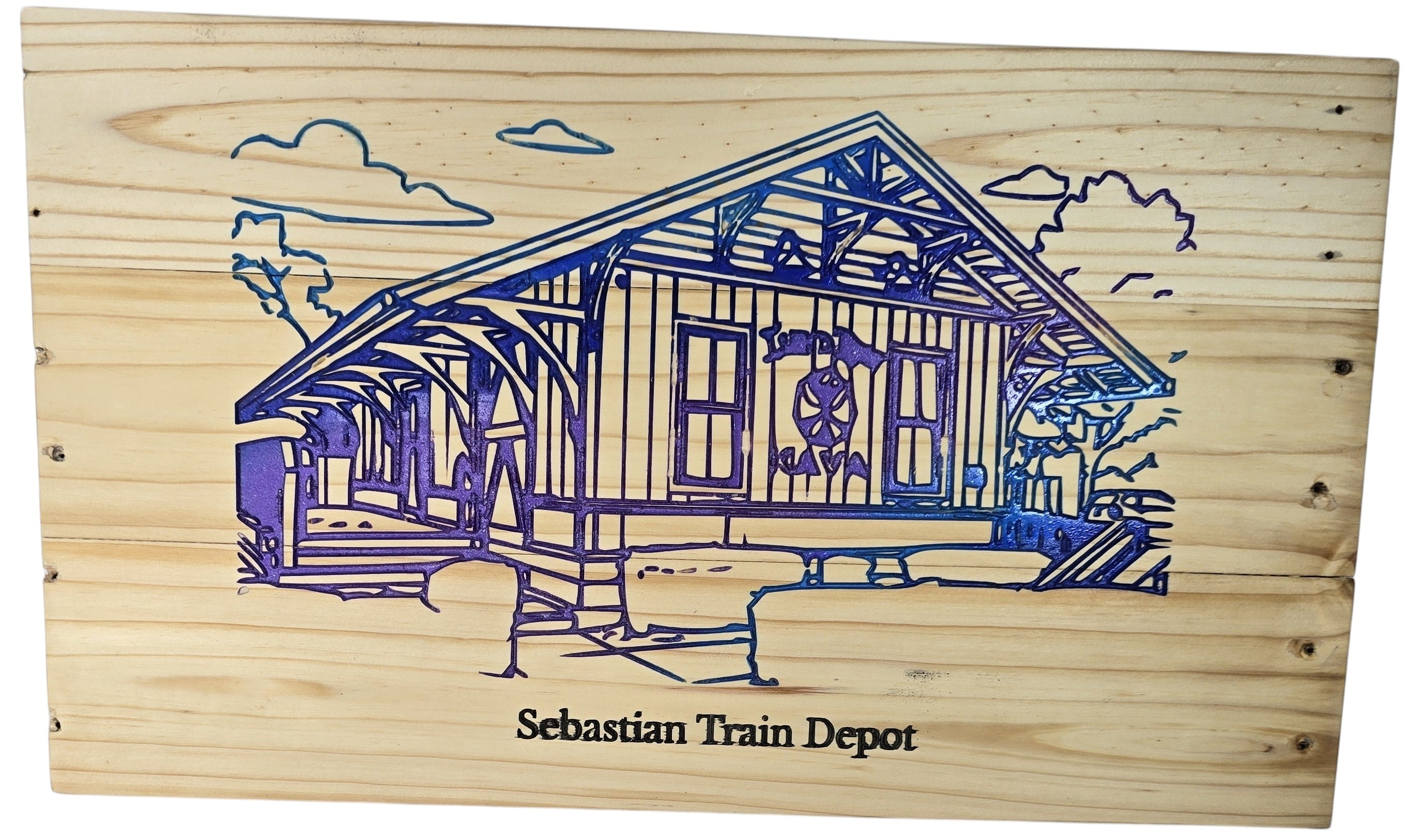 TK Wood Designs Sebastian Train Depot wooden art, featuring a blue and purple engraved depiction of the historic station with clouds and trees.
