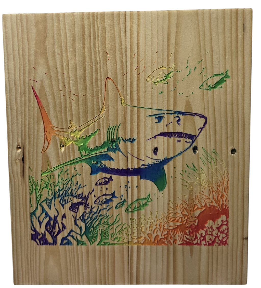 TK Wood Designs natural wood wall art featuring a rainbow shark swimming with fish and coral.