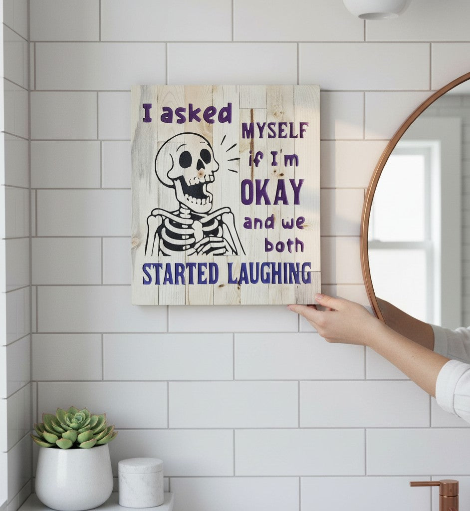 TK Wood Designs reclaimed wood sign with a skeleton graphic and purple text reading "I asked MYSELF if I'm OKAY and we both STARTED LAUGHING."