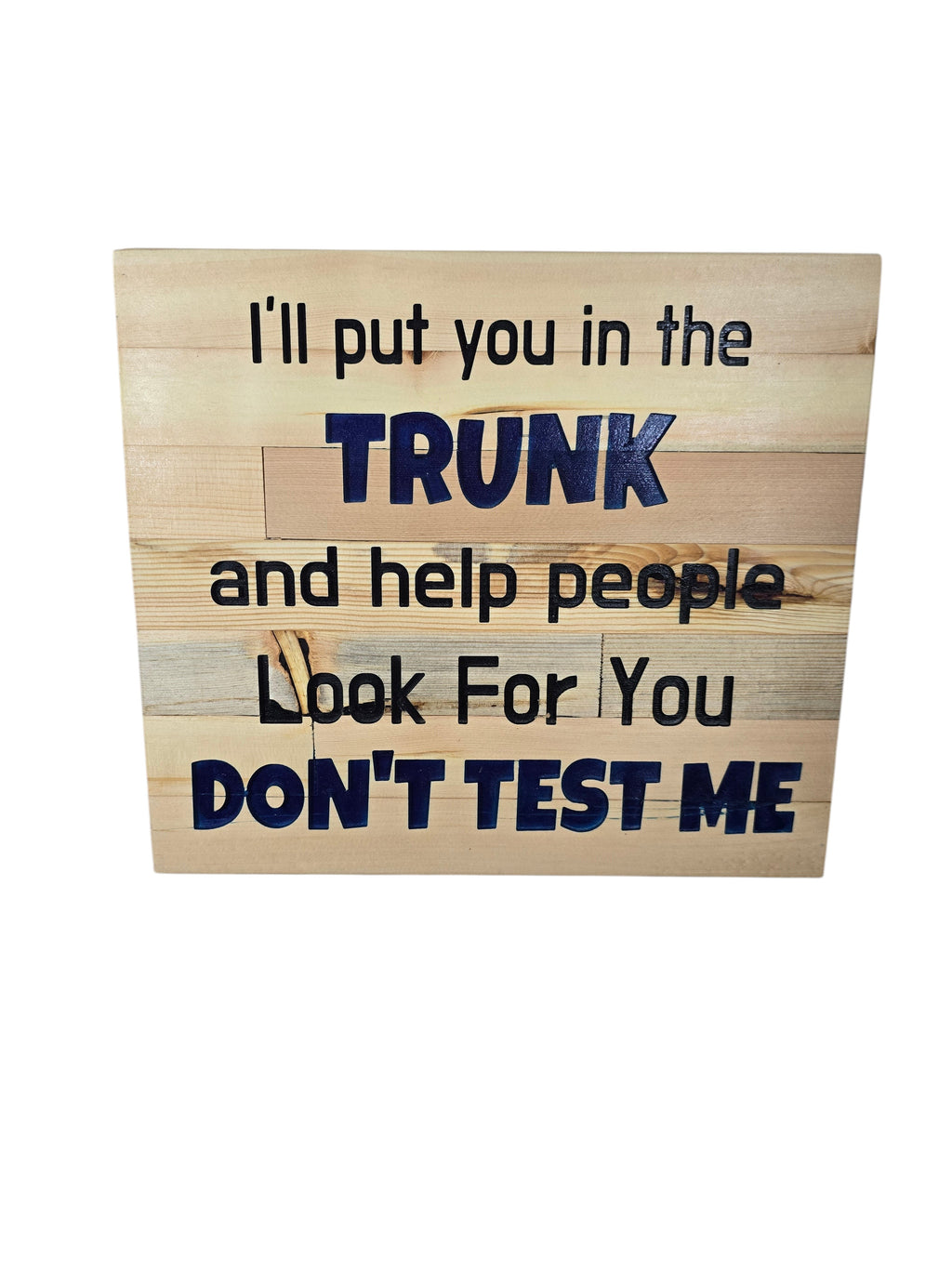 TK Wood Designs natural wood wall art with bold blue text: "I'll put you in the TRUNK and help people Look For You DON'T TEST ME."