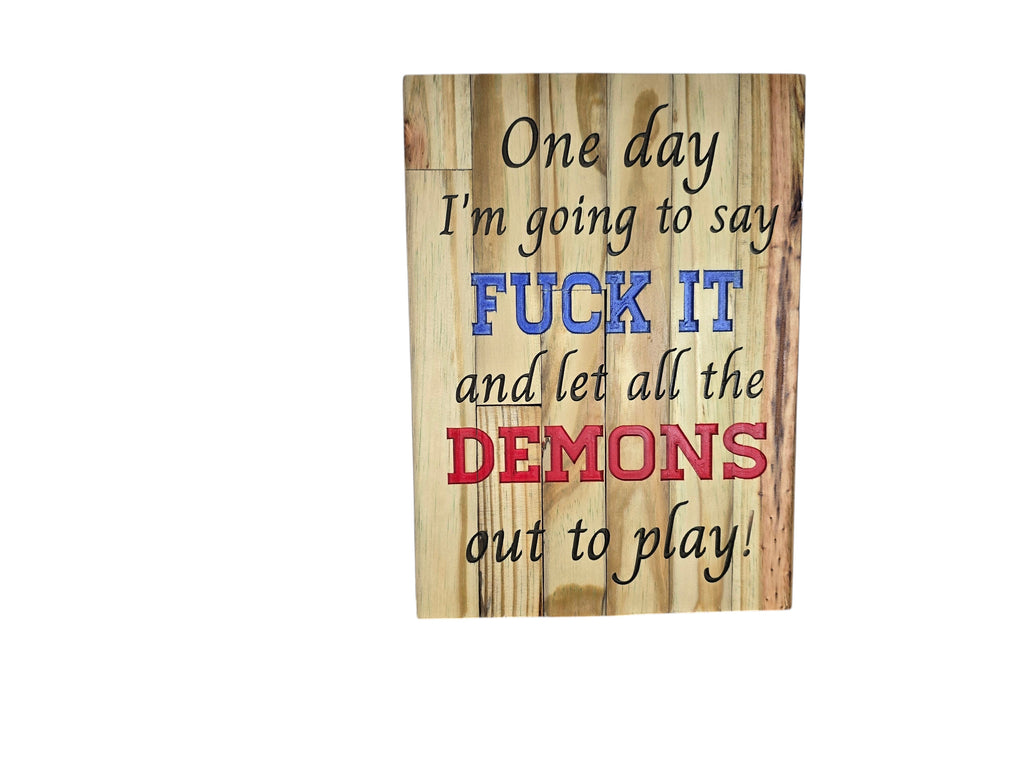 TK Wood Designs natural wood sign with black text, blue "FUCK IT" and red "DEMONS" saying "One day I'm going to say FUCK IT and let all the demons out to play!"