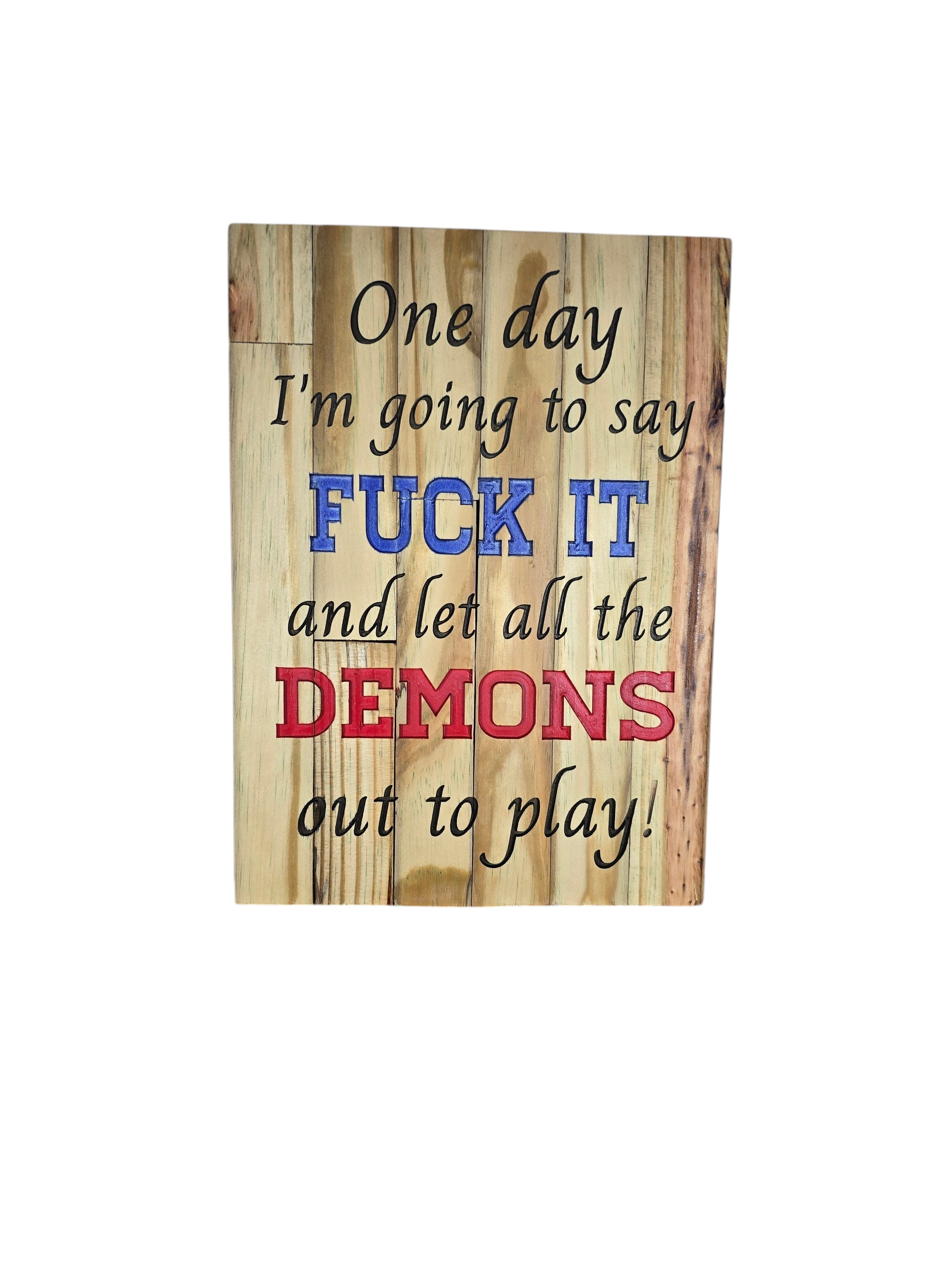 TK Wood Designs natural wood sign with text "One day I'm going to say FUCK IT and let all the DEMONS out to play!" Blue and red lettering.