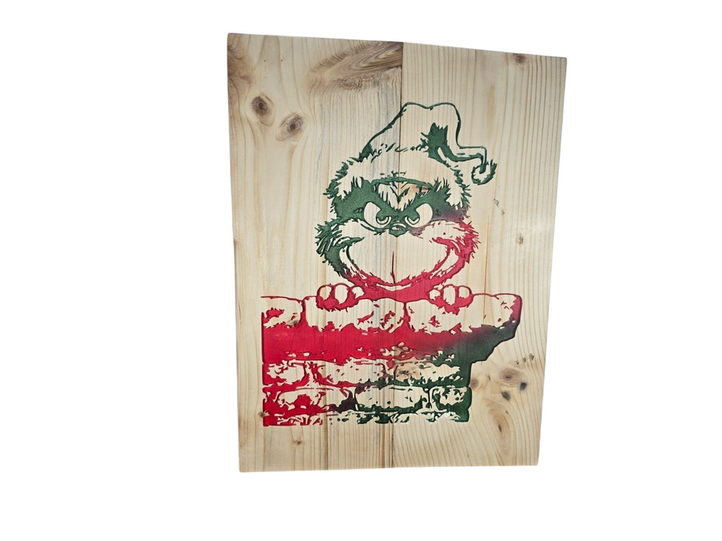 TK Wood Designs rustic wooden wall sign featuring a festive character peering over a red and green brick chimney.