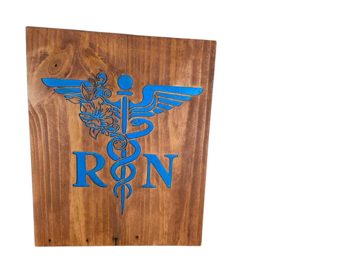 TK Wood Designs wooden sign featuring a blue engraved caduceus symbol and RN lettering for a nurse gift.