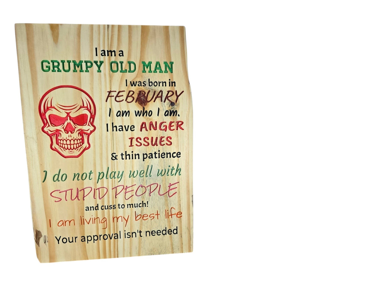 TK Wood Designs wooden sign featuring a skull graphic and humorous text about being a grumpy man born in February.