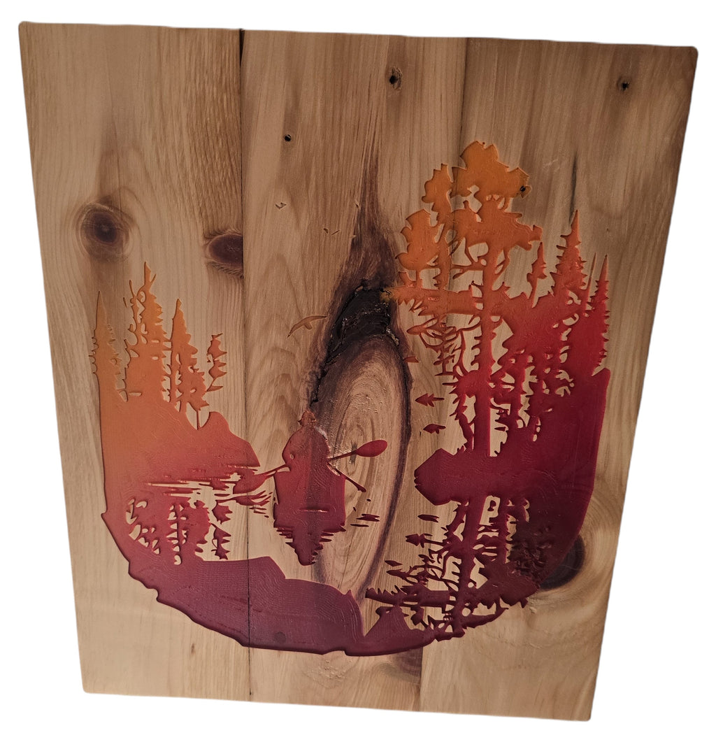 TK Wood Designs rustic woodland scene wall art with kayaker, forest silhouette in orange and red on natural wood.