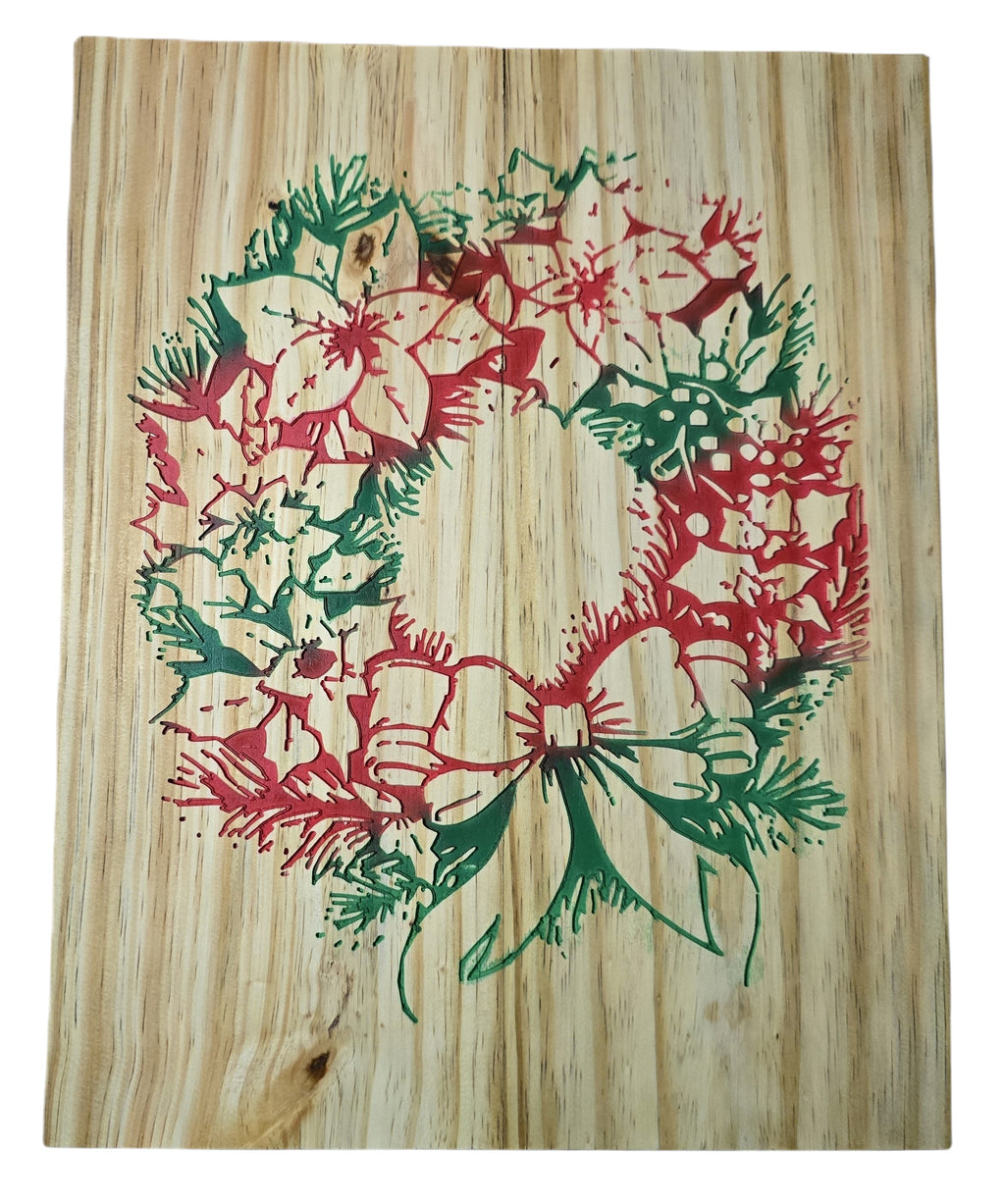 TK Wood Designs rustic Christmas wreath carved into wood, featuring red poinsettias and green pine needles with a bow.