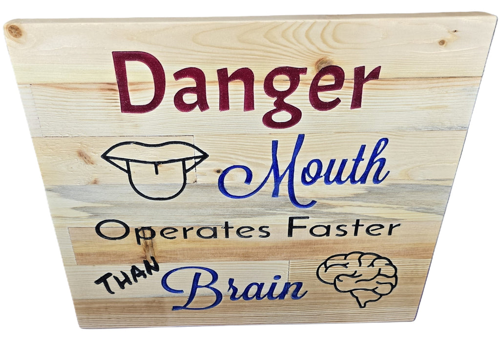 TK Wood Designs natural wood plank wall art with "Danger Mouth Operates Faster Than Brain" text, mouth, and brain illustrations.