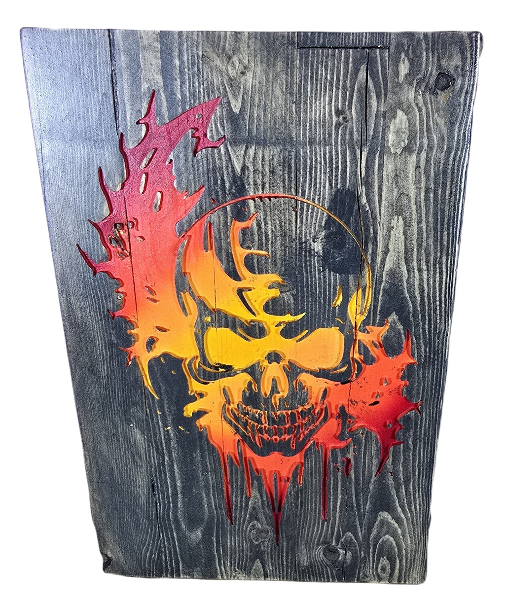 TK Wood Designs distressed wood wall art featuring a fiery skull in red, orange, and yellow. Rustic texture.