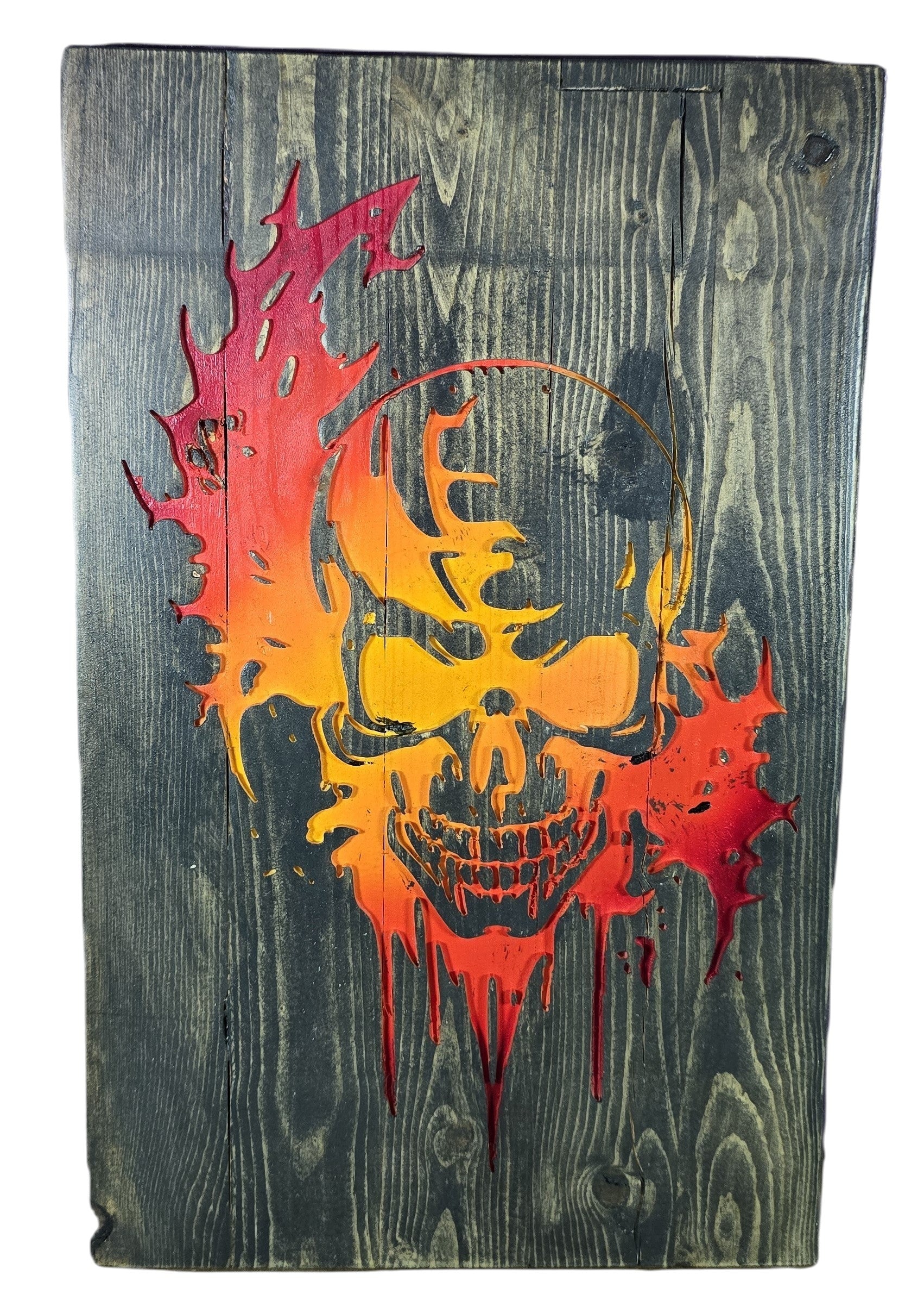 TK Wood Designs distressed wood wall art featuring a fiery skull in red, orange, and yellow. Rustic texture.