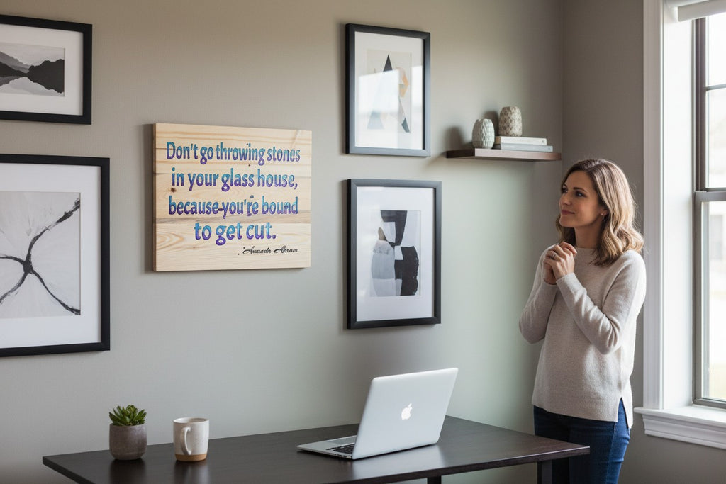 TK Wood Designs wooden sign with blue and purple lettering reading "Don't go throwing stones in your glass house, because you're bound to get cut."