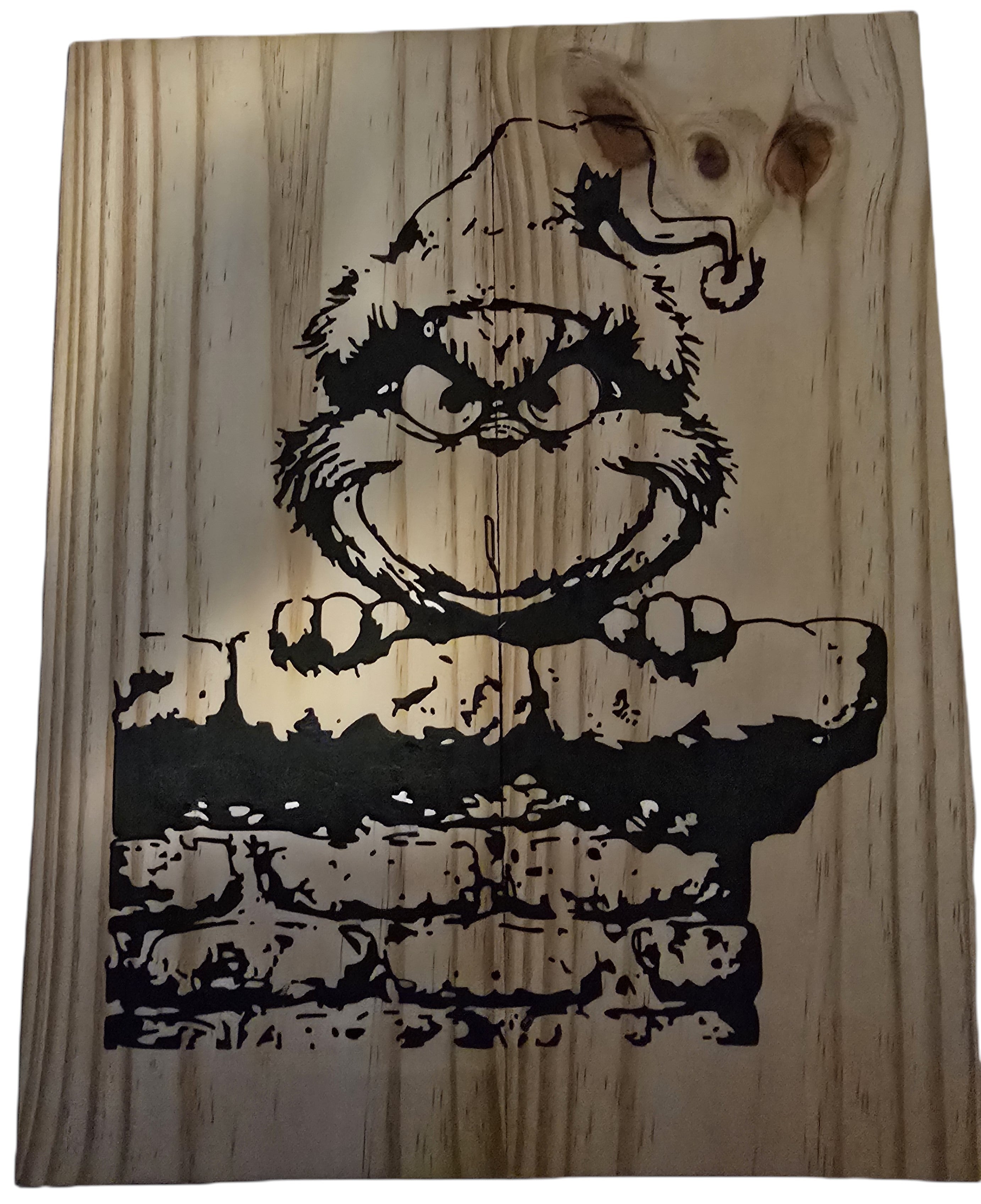 TK Wood Designs Grinch salvaged wood sign with black graphic of the Grinch peeking over a brick wall. Natural wood grain.